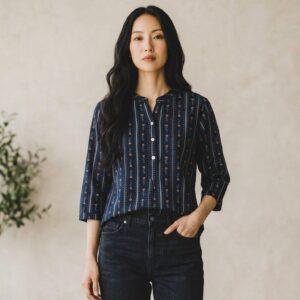 Women's navy blue floral printed top featuring delicate botanical motifs and a modern relaxed silhouette.